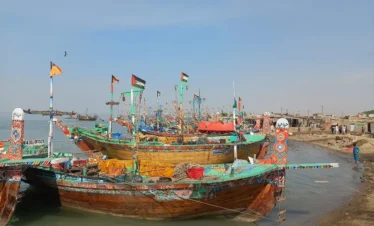 "Fishermen pulling nets along the coast in Thatta"