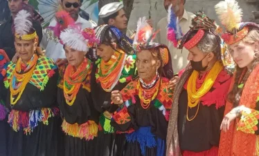 Tourists joining locals during the Chaumos Festival in Kalash Valley"