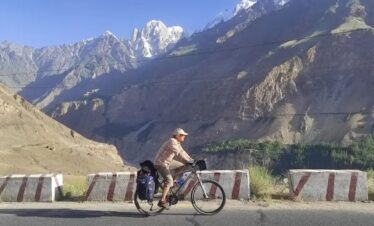 Cyclists ride through scenic valleys and mountains on a northern Pakistan tour during an unforgettable cycle tour in Pakistan