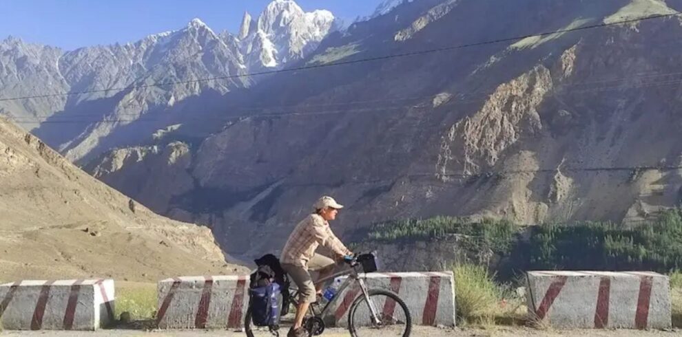Cyclists ride through scenic valleys and mountains on a northern Pakistan tour during an unforgettable cycle tour in Pakistan