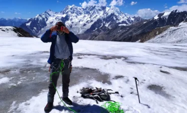 Climbers ascending a snowy ridge in Yasin Valley, Pakistan