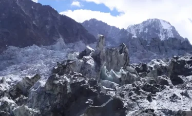 Base camp under glacier-covered peaks in Yasin Valley