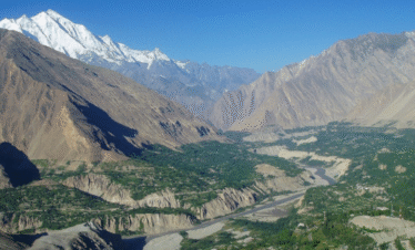 "Apricot Tour in Hunza Valley with blooming orchards and majestic mountains"