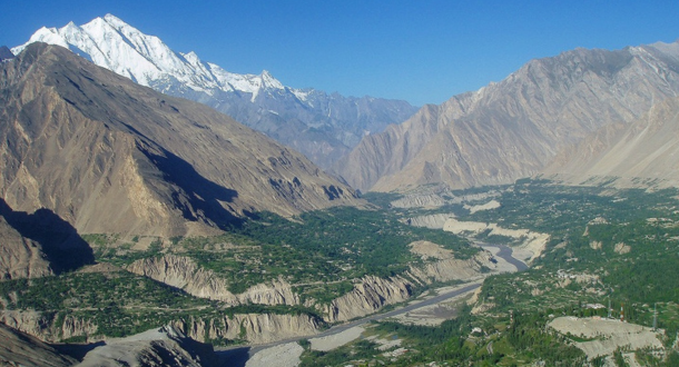 "Apricot Tour in Hunza Valley with blooming orchards and majestic mountains"