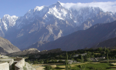 "Hunza Valley apricot blossom season with snowy peaks in the background"