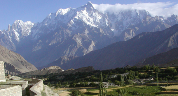 "Hunza Valley apricot blossom season with snowy peaks in the background"